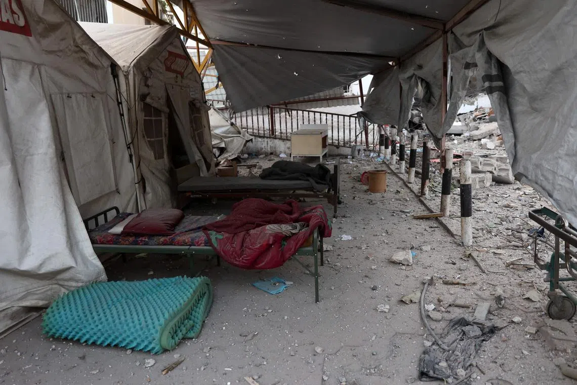 Beds sit amid the debris in the aftermath of an Israeli strike on the Al-Ahli hospital in Gaza City on April 13.