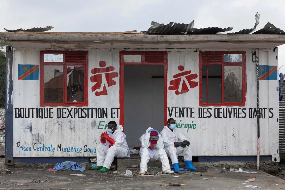 Red Cross volunteers resting while waiting for the truck carrying the bodies of victims who died in a jailbreak and fire at Munzenze central prison during the capture of the city by M23 rebels in Goma, North Kivu province, Democratic Republic of Congo, Feb 10, 2025. 
