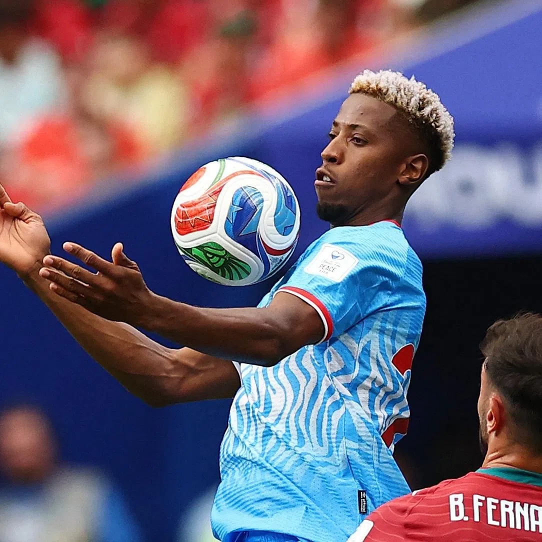 Soccer Football - FIFA World Cup 2026 - Group K - Portugal v DR Congo - Houston Stadium, Houston, Texas, U.S. - June 17, 2026 DR Congo's Simon Banza in action with Portugal's Bruno Fernandes REUTERS/Pedro Nunes