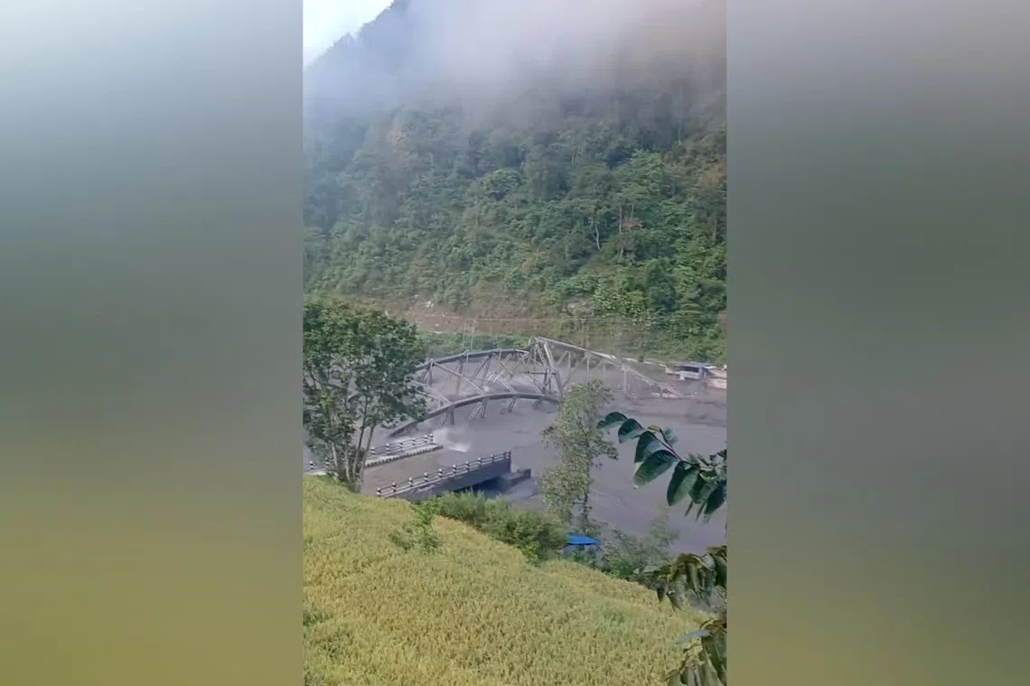 Floodwaters wash away the collapsed Soti Bridge on Budhi Gandaki River, in Chumnubri village, in Gorkha District, Nepal, on Oct 11.