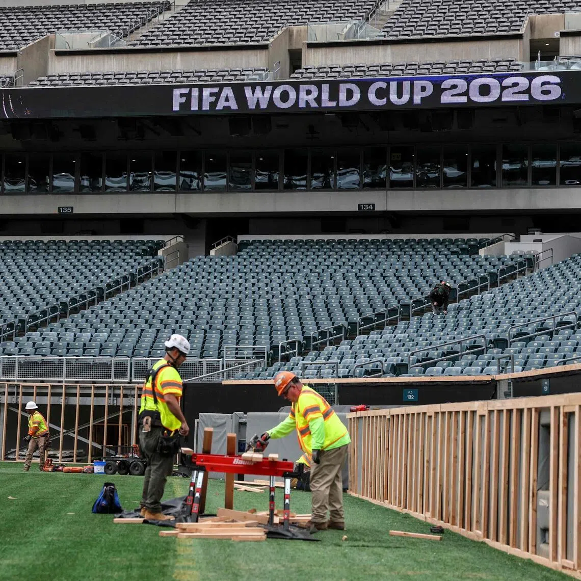 Workers prepare the field at Lincoln Financial Field, one of the stadiums hosting the 2026 FIFA World Cup in Philadelphia.