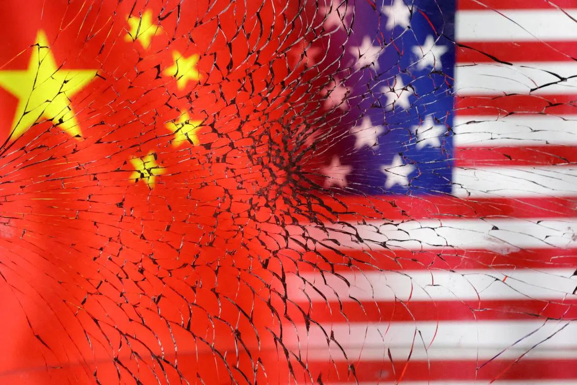 FILE PHOTO: U.S. and Chinese flags are seen through broken glass in this illustration taken, January 30, 2023. REUTERS/Dado Ruvic/Illustration/File Photo