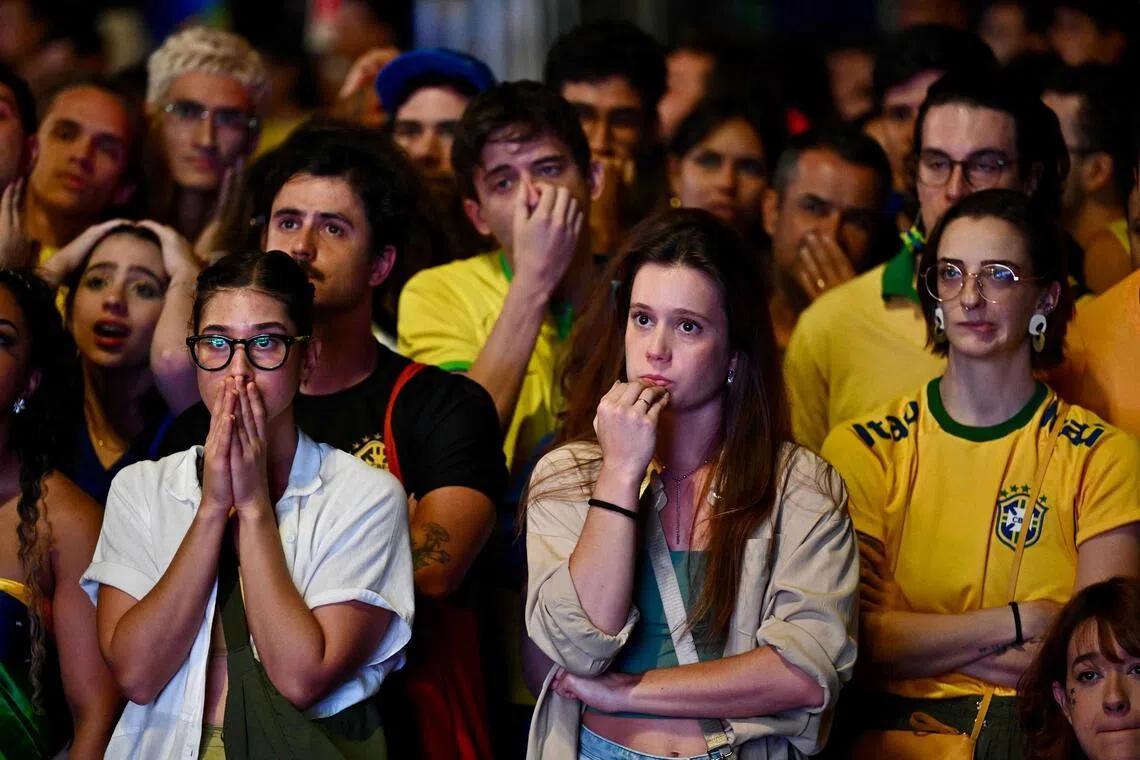 Brazilian fans reacting as they watch the live broadcast of the match between Brazil and Norway on a street in Brasilia, on July 5.