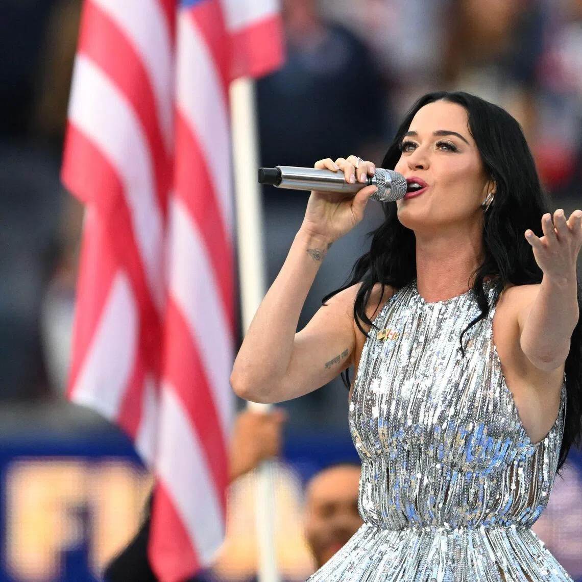 Katy Perry sings the national anthem ahead of the 2026 World Cup Group D football match between USA and Paraguay at SoFi Stadium  on June 12, 2026. 