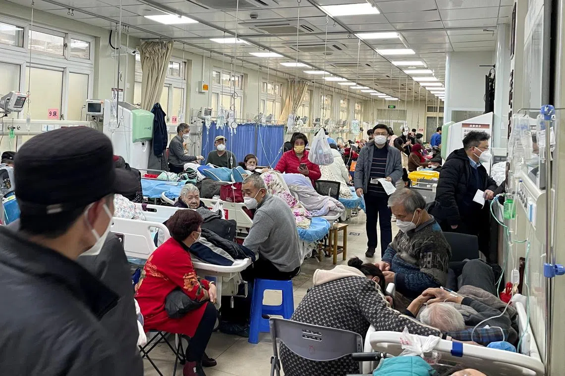 Patients lie on beds in the emergency department of a hospital, amid the Covid-19 outbreak in Shanghai on Jan 4, 2023.
