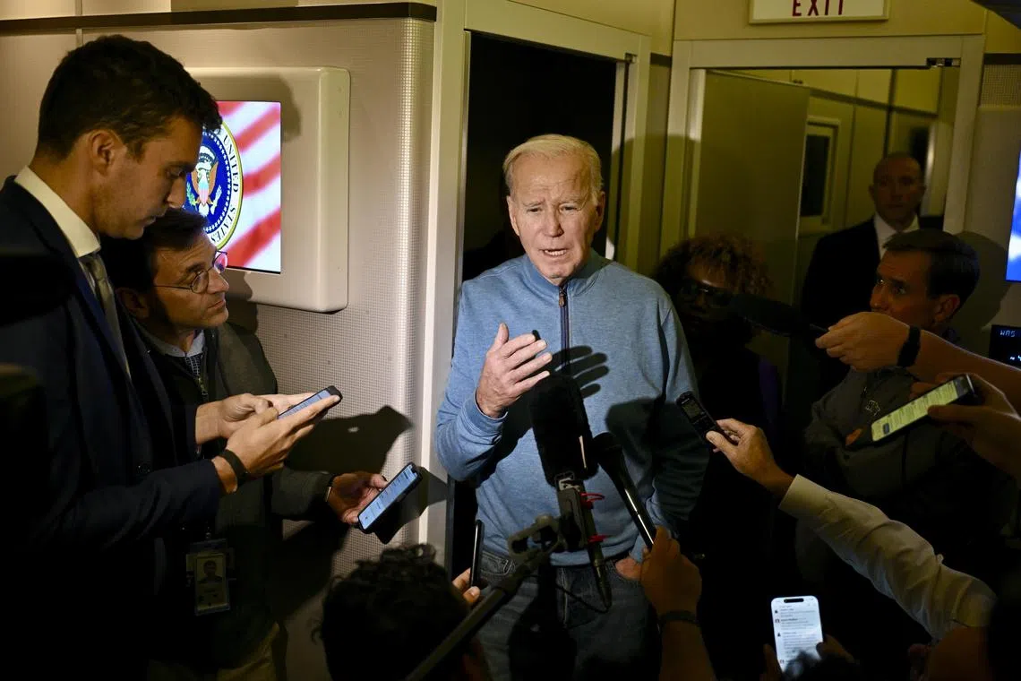 President Joe Biden speaks to reporters aboard Air Force One while refueling at Ramstein Air Base in Germany, after visiting Israel.