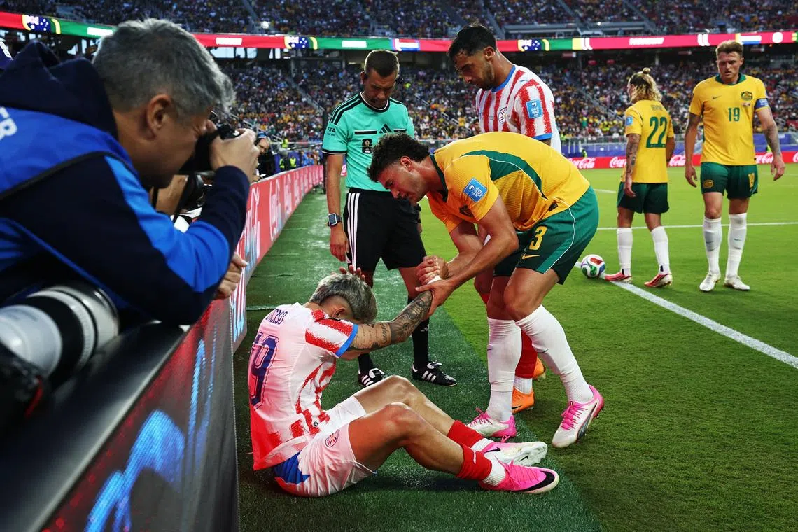 Soccer Football - FIFA World Cup 2026 - Group D - Paraguay v Australia - San Francisco Bay Area Stadium, Santa Clara, California, U.S. - June 25, 2026 Paraguay's Julio Enciso is checked on by Australia's Alessandro Circati after sustaining an injury REUTERS/Eloisa Lopez