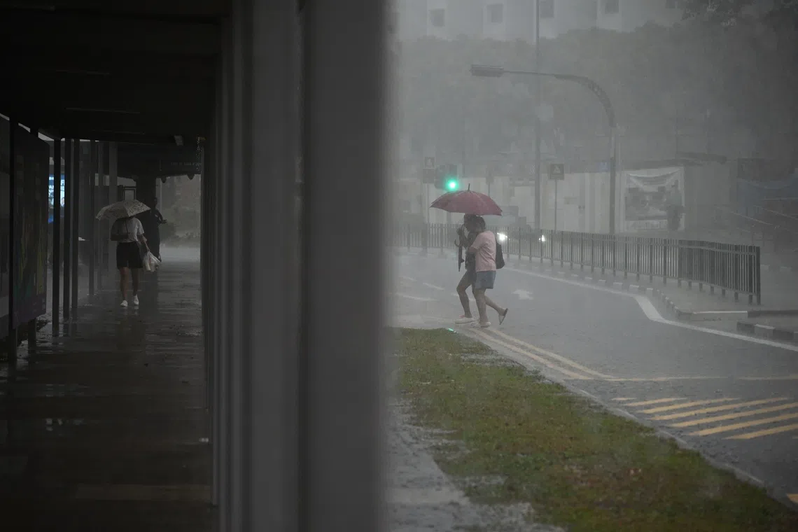 People caught in the heavy downpour in Toa Payoh Lorong 8 at 8am on Oct 15.