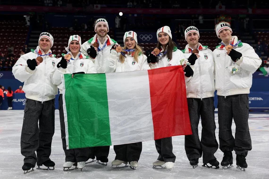 Milano Cortina 2026 Olympics - Figure Skating - Team Event - Victory Ceremony - Milano Ice Skating Arena, Milan, Italy - February 08, 2026. Bronze medallist's Matteo Rizzo, Lara Naki Gutmann, Sara Conti, Niccolo Macii, Daniel Grassl, Charlene Guignard and Marco Fabbri of Italy celebrate after finishing third in the Team Event REUTERS/Claudia Greco