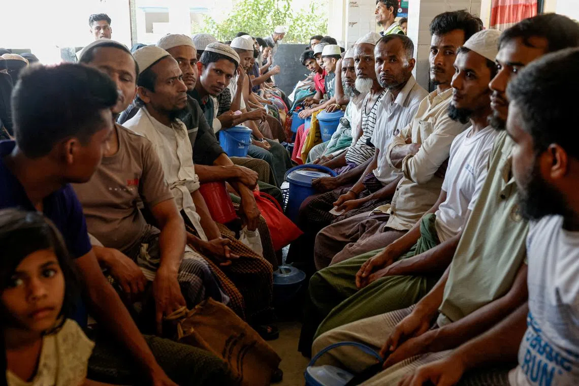 FILE PHOTO: Rohingya refugees wait at the World Food Programme distribution center to purchase grocery items, at the refugee camp in Cox's Bazar, Bangladesh, March 15, 2025. REUTERS/Mohammad Ponir Hossain/File Photo