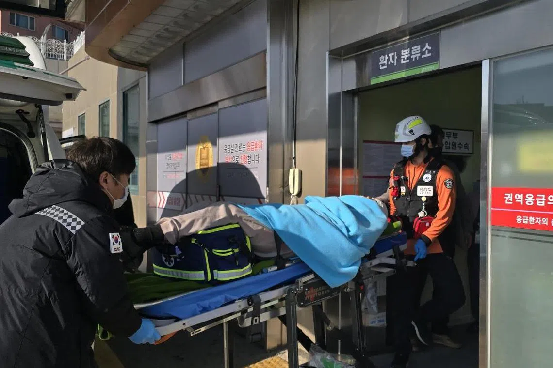 epa11796544 A passenger rescued from a plane crash at Muan International Airport is transported to a nearby hospital, in Muan, 288 kilometers southwest of Seoul, South Korea, 29 December 2024.  EPA-EFE/YONHAP SOUTH KOREA OUT