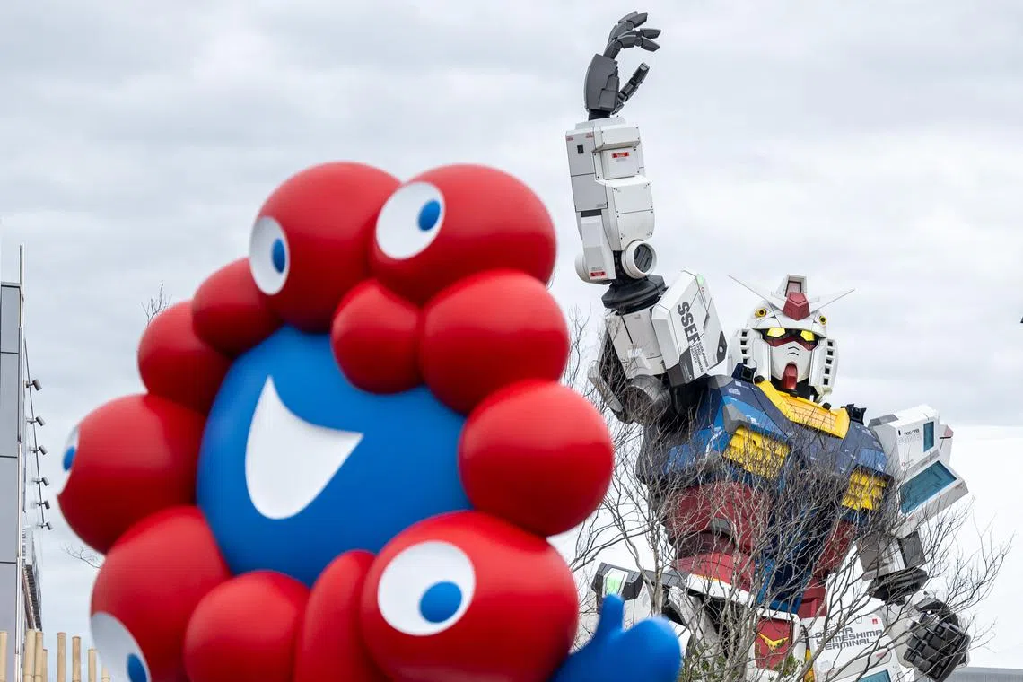 A general view shows the "Myaku-Myaku", the mascot of the 2025 Osaka Expo as the Gundam pavilion is seen behind on the first day of the six-month event on April 13.