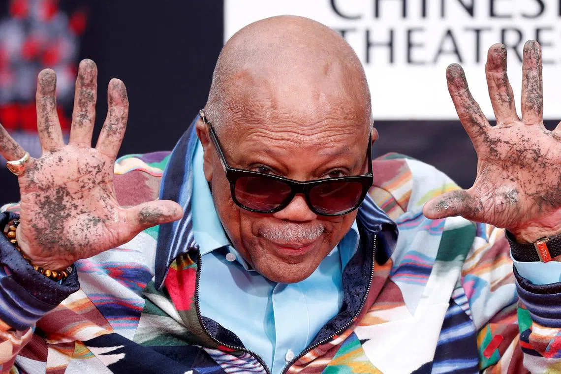 FILE PHOTO: Composer Quincy Jones shows his hands after placing them in cement during a ceremony in the forecourt of the TCL Chinese theatre in Los Angeles, California, U.S., November 27, 2018. REUTERS/Mario Anzuoni/File Photo