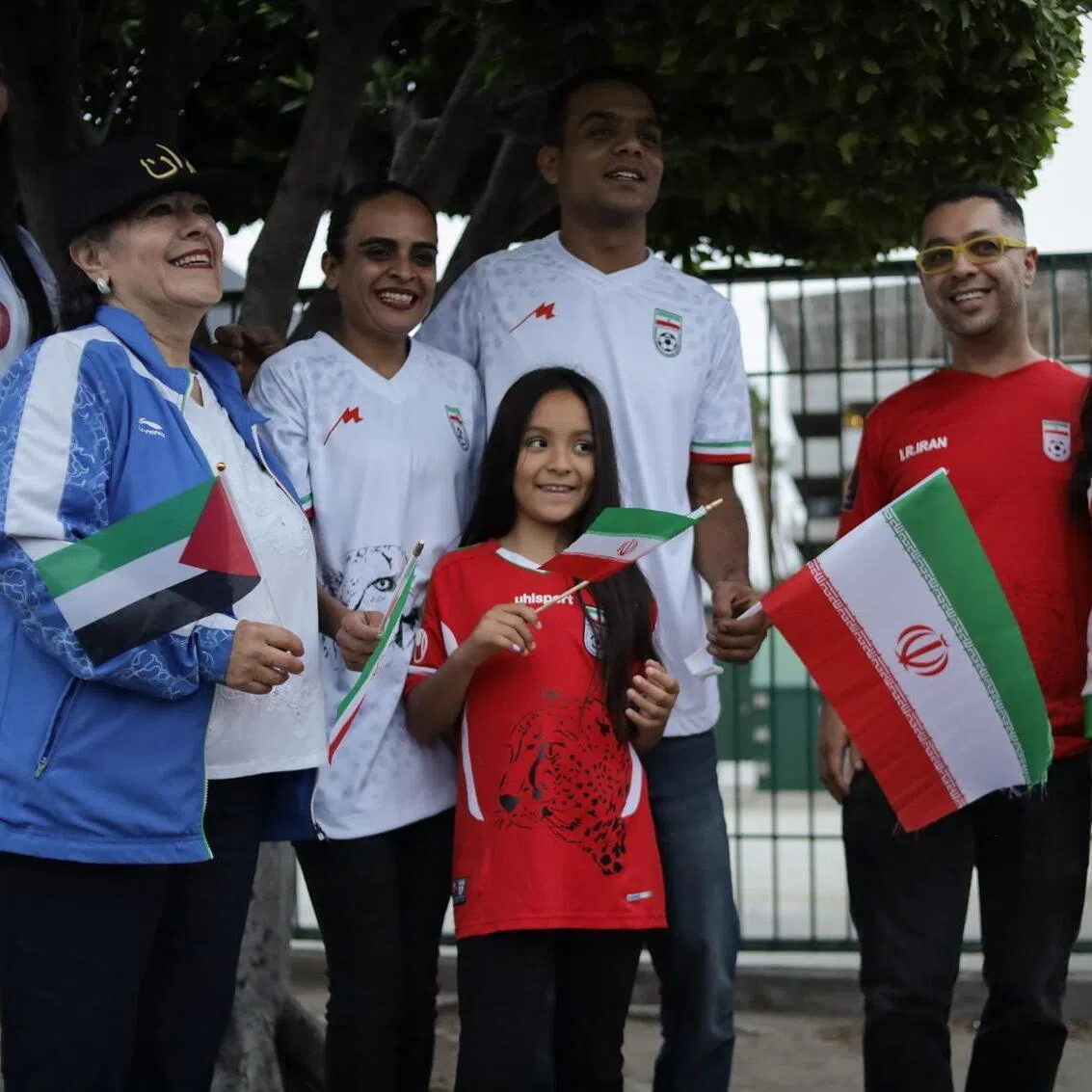 Fans react as the Iranian national team arrives at the Tijuana International Airport, near Tijuana, Mexico.