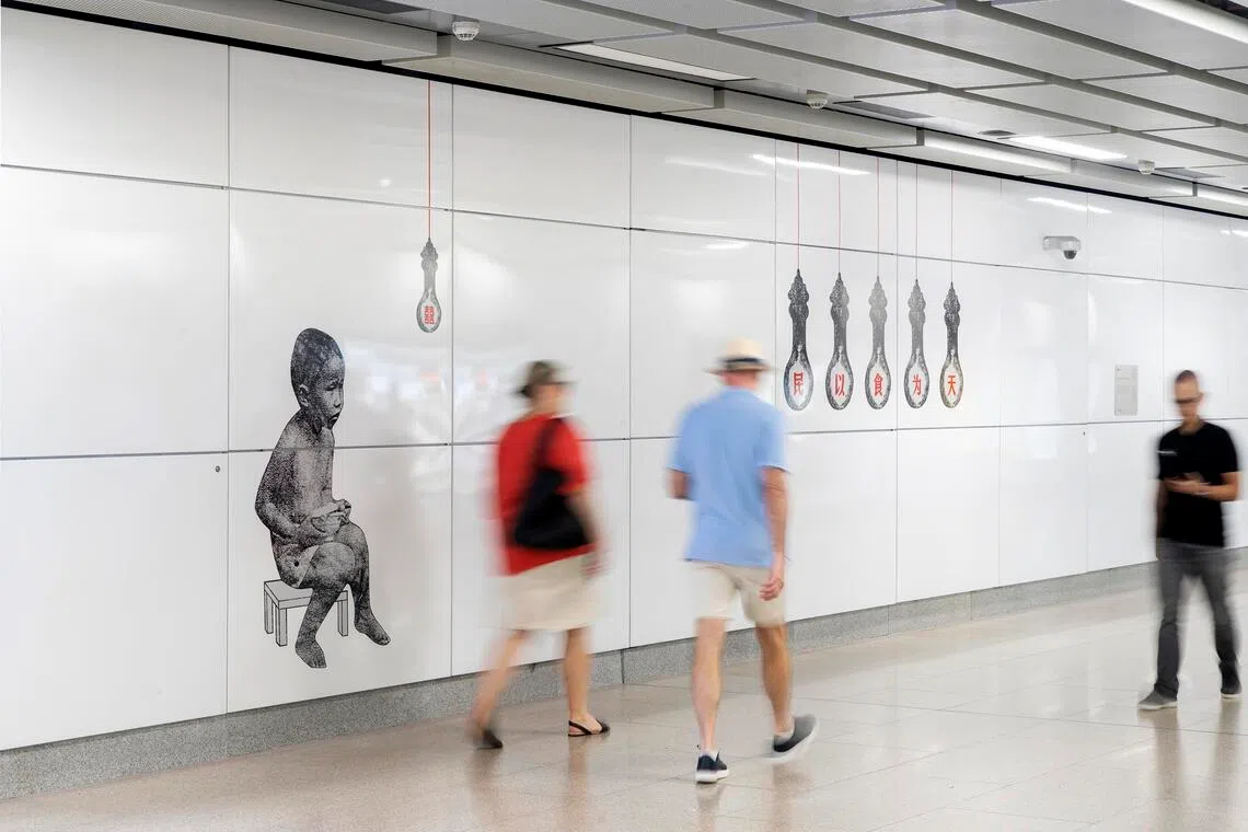 Hawker lightbulbs and a child eating suggest the way towards Maxwell Food Centre at Maxwell MRT station.