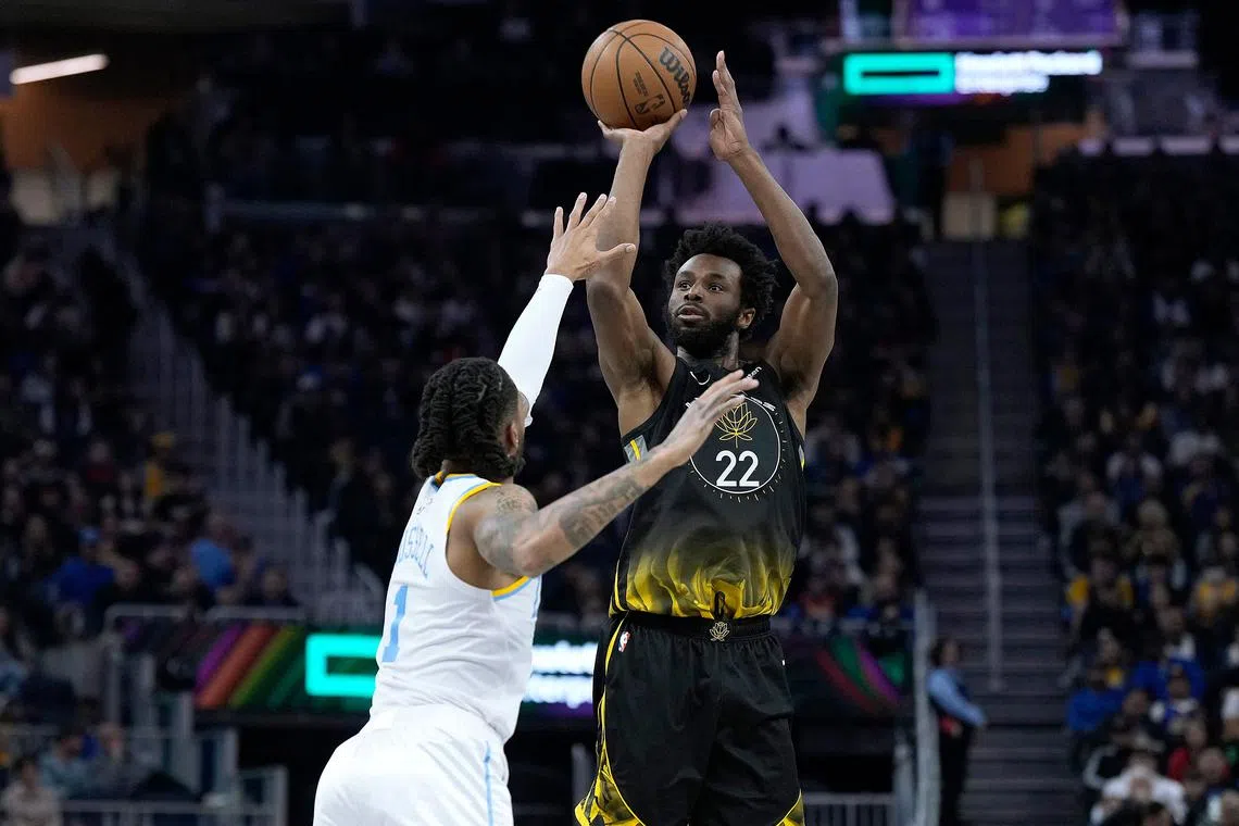Andrew Wiggins of the Golden State Warriors shoots over D'Angelo Russell of the Los Angeles Lakers on Feb 11, 2023.