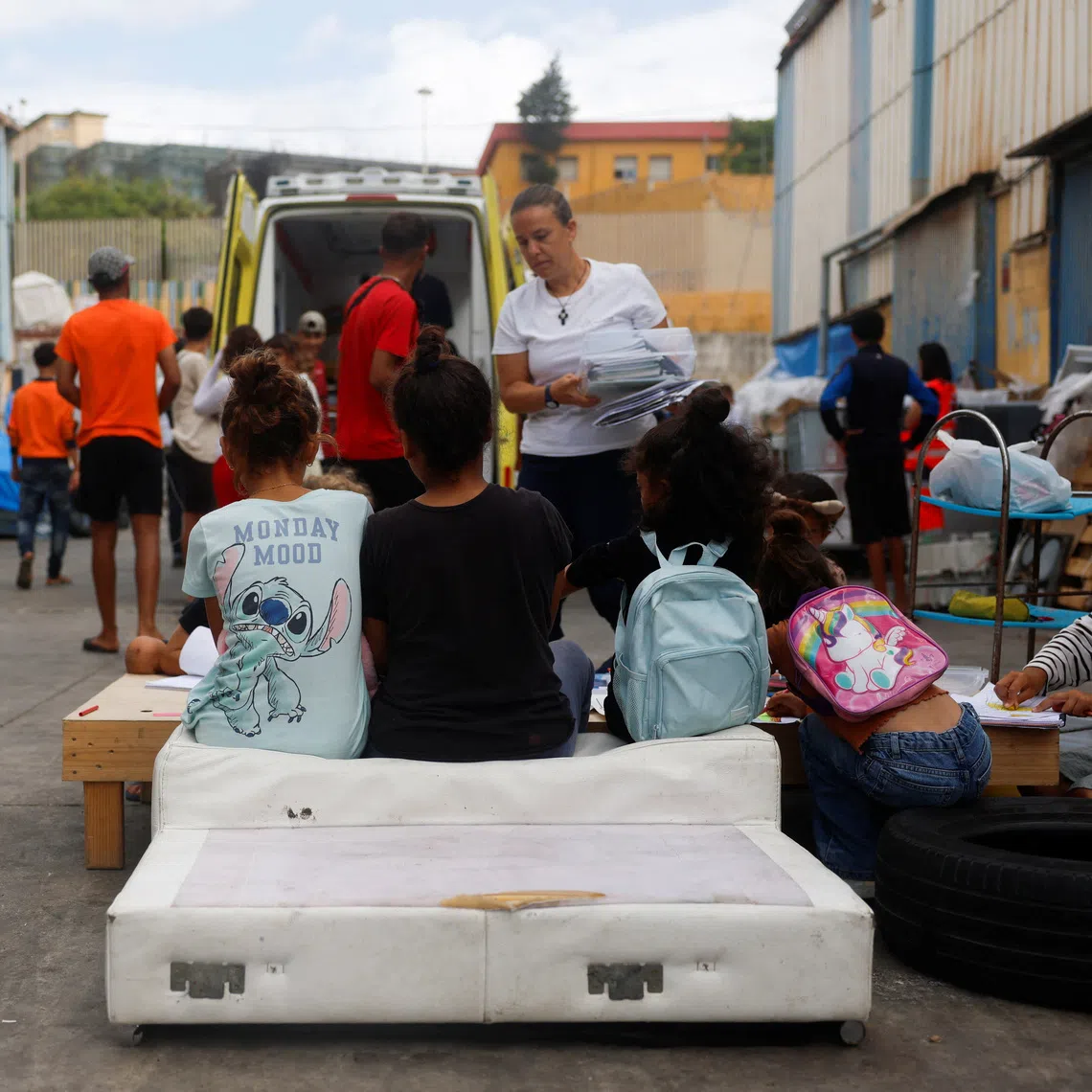 Members of a Spanish NGO Doctors of the World teach drawing to migrants minors at an industrial area, following the mass crossing of migrants from Morocco, in Ceuta, Spain.