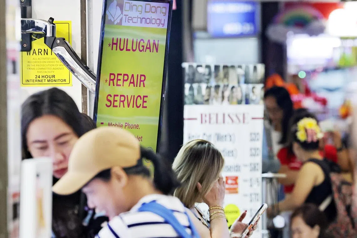 At Lucky Plaza, there are many shops advertising hulugan, the Tagalog term used for instalment plans.