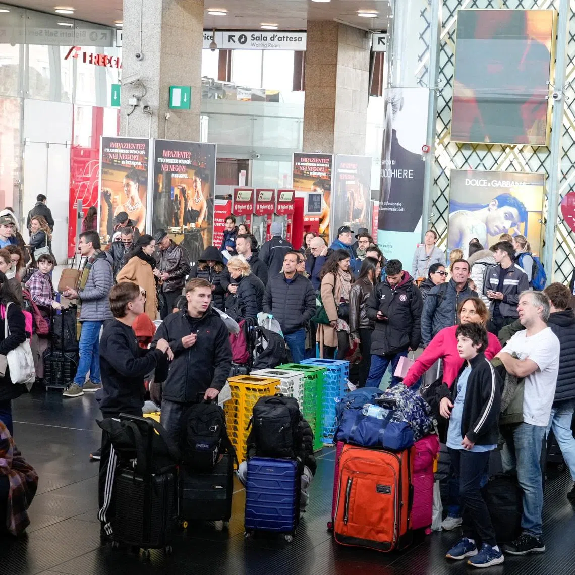 Passengers wait inside Termini train station after train services in Italy were disrupted during the Olympics, in Rome on Feb 14.