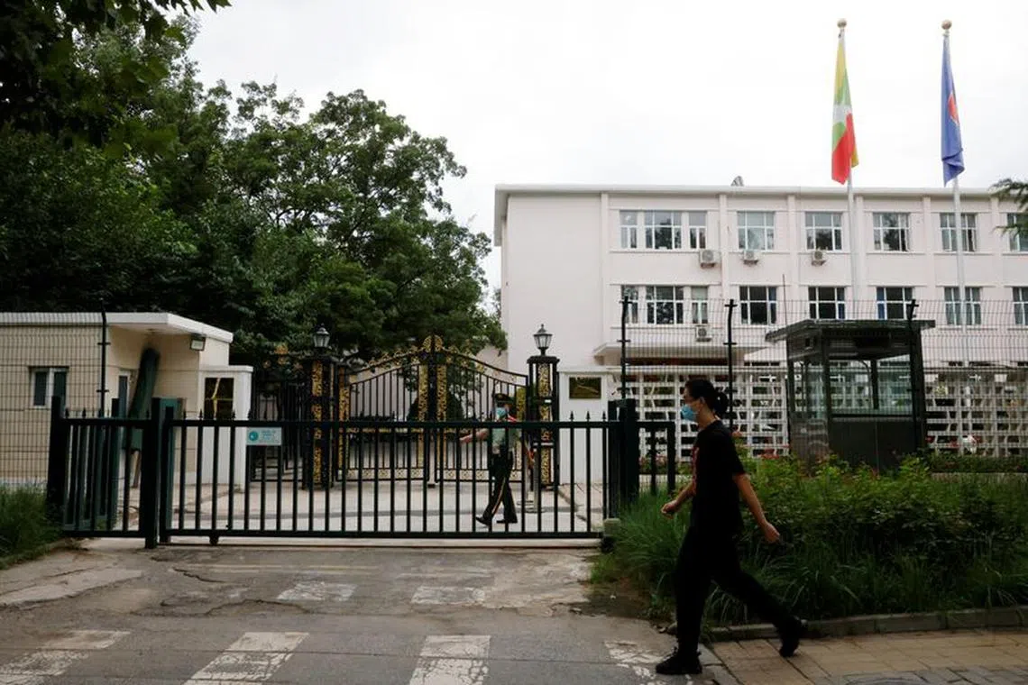 FILE PHOTO: A man walks past a paramilitary police officer keeping watch outside the Myanmar embassy in Beijing, China August 8, 2022. REUTERS/Carlos Garcia Rawlins/File photo