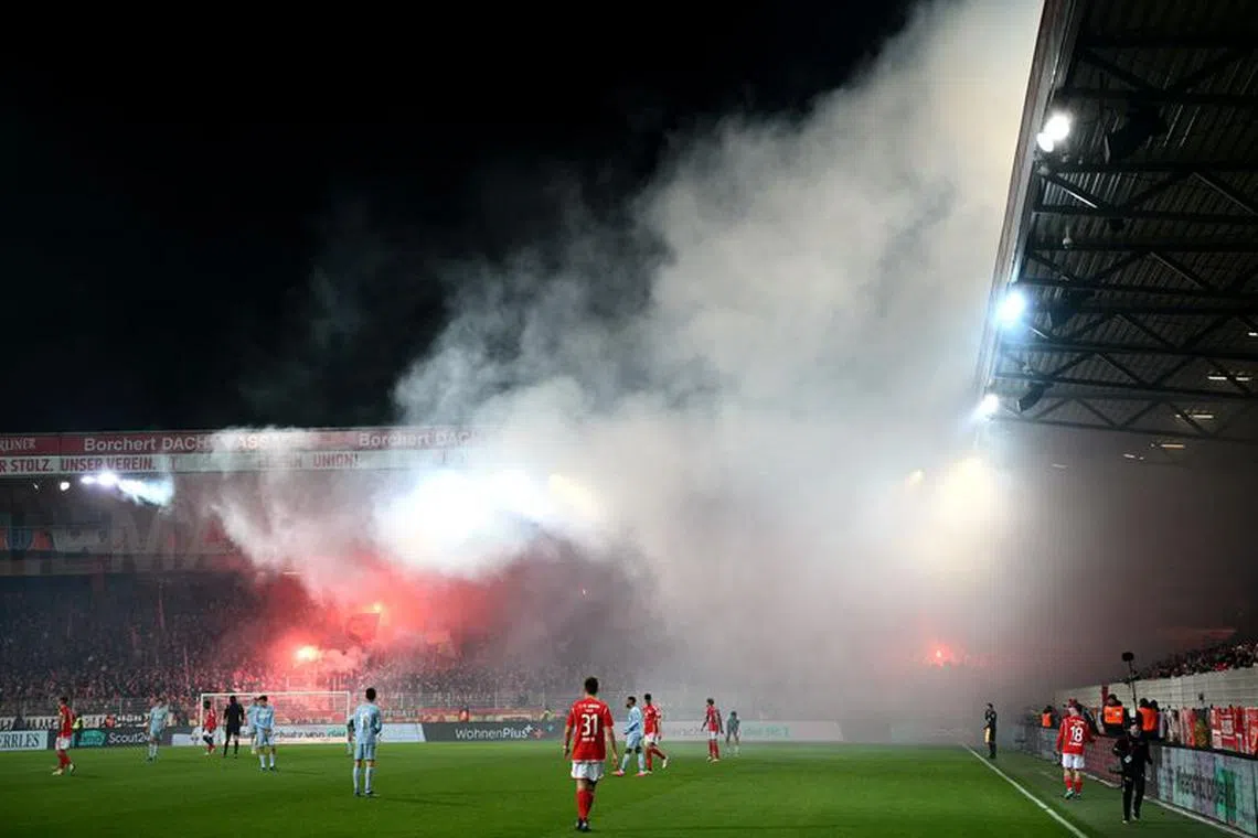 FILE PHOTO: Soccer Football - Bundesliga - 1. FC Union Berlin v FC Cologne - Stadion An der Alten Forsterei, Berlin, Germany - December 20, 2023 General view of flares during the match REUTERS/Annegret Hilse/File Photo
