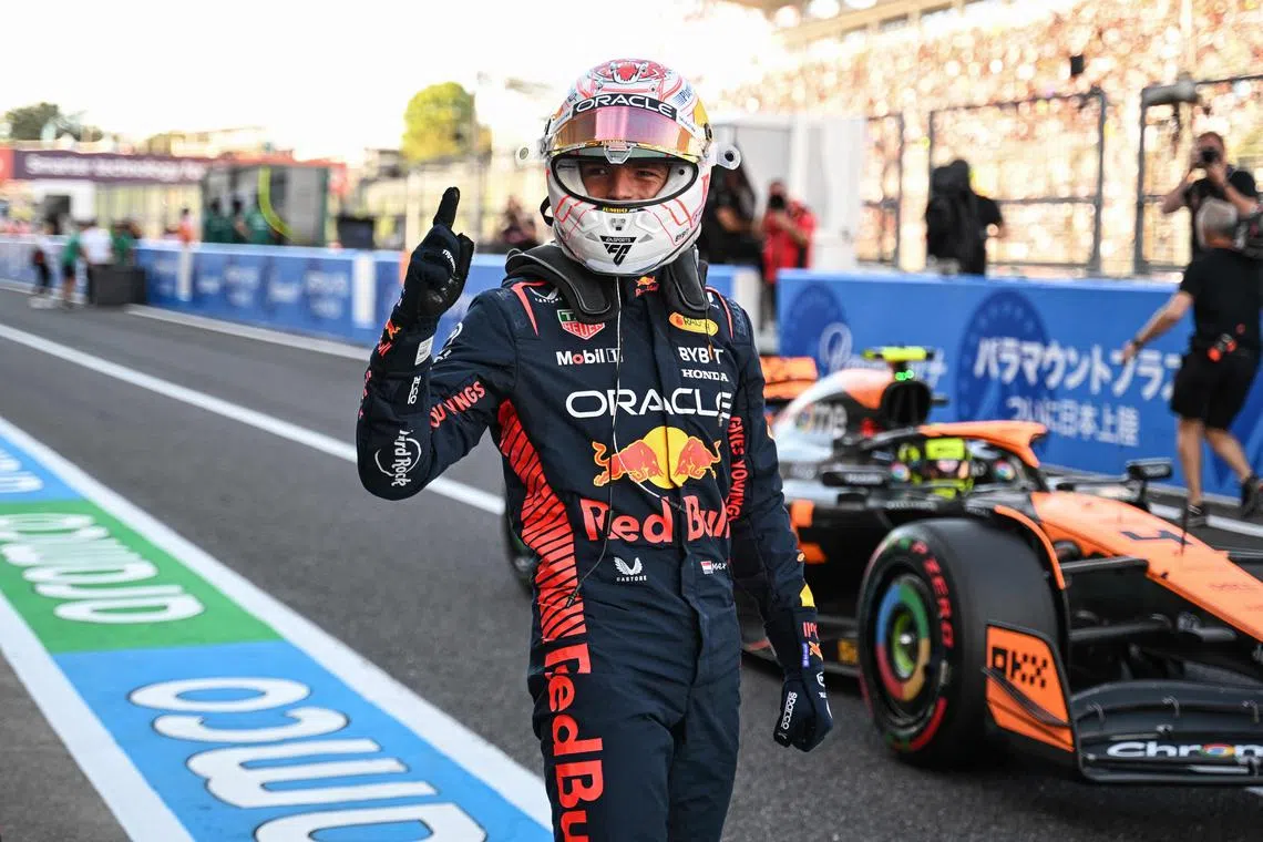 Red Bull's Max Verstappen celebrates after taking pole position for the Japanese Grand Prix.