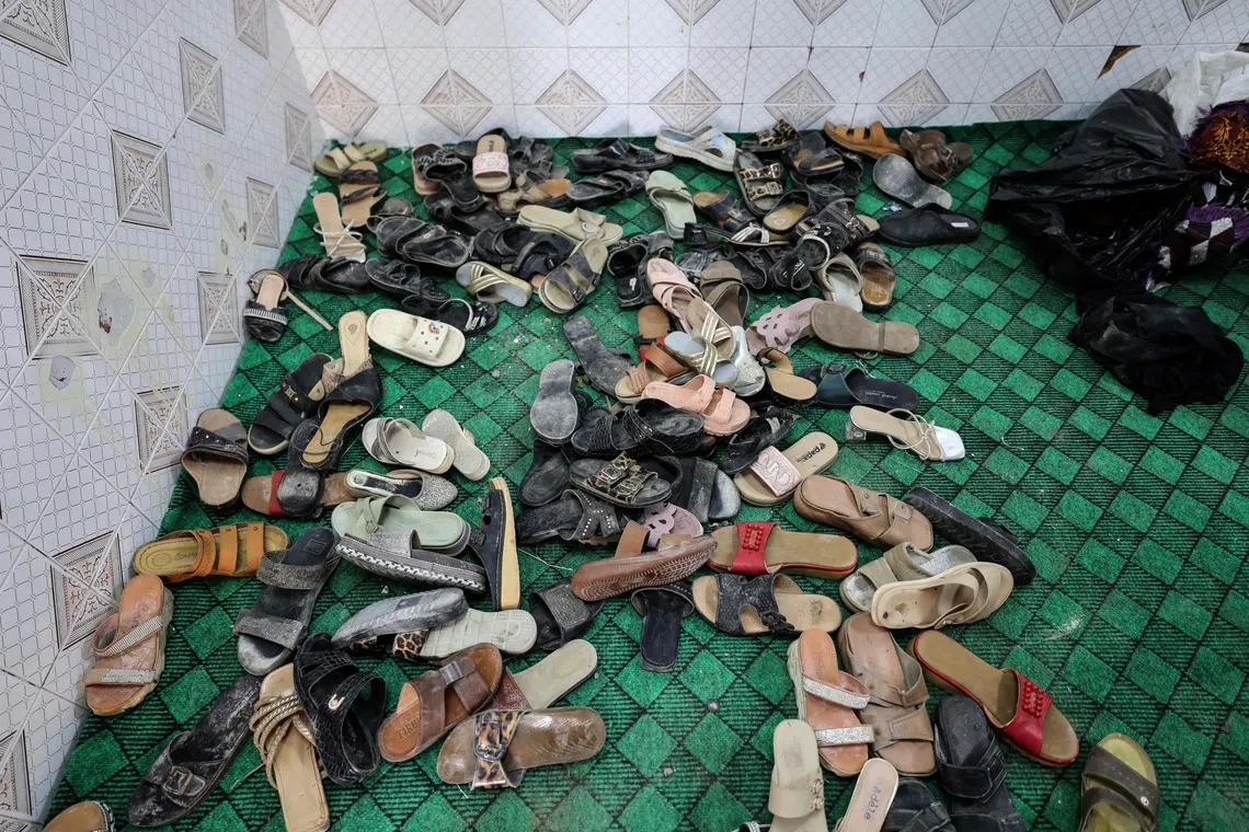 A pile of shoes litter the floor following a US strike earlier in the week on Kuhestak, Sirik County, in Iran's southern Hormozgan province on September 6, 2026. A deadly US strike hit a wedding celebration on the night of September 2, 2026, in the coastal town of Kuhestak along Strait of Hormuz in southern Iran, with the Iranian authorities saying it killed at least four people, including a child, and wounded 68 others attending the wedding. The United States announced attacks against targets belonging to Iran's Revolutionary Guards. Iran has been at war since February 28, when the United States and Israel launched a surprise bombing campaign that killed its supreme leader. (Photo by ATTA KENARE / AFP) /