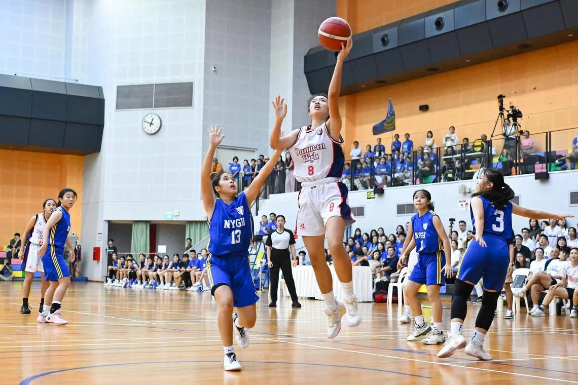 Nanyang Girls' High School's Jovia Teo (centre, left) blocking Dunman High School's Oh Yu Tong during the National School Games B Division girls' basketball final on April 28.