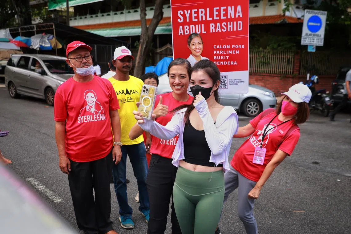 Pakatan Harapan candidate Syerleena Abdul Rashid (third from right) greets supporters during a walkabout in Georgetown, Penang on Nov 16, 2022.