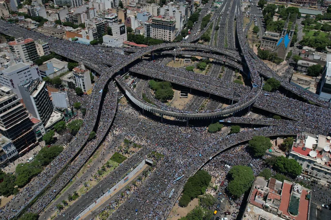 An aerial photo taken with a drone shows fans of Argentinian national soccer team celebrating during the victory parade, Dec 20, 2022. 
