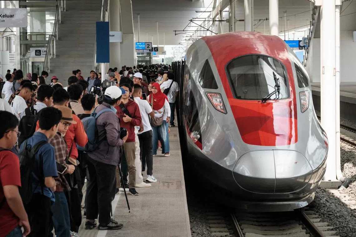 People take pictures with the first car of the Jakarta-Bandung high-speed train during a week-long public trial phase at the Tegalluar station in Bandung, West Java, on Sept 17, 2023. 