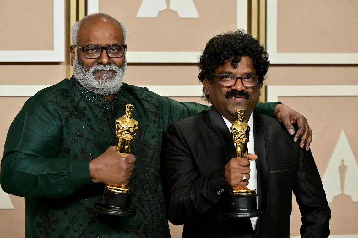 Indian musical composer M.M. Keeravaani (left) and Indian lyricist Chanrabose (right) pose with the Oscar for Best Music (Original Song) for their song Naatu Naatu in RRR in the press room during the 95th Annual Academy Awards at the Dolby Theatre in Hollywood, California on March 12, 2023. 