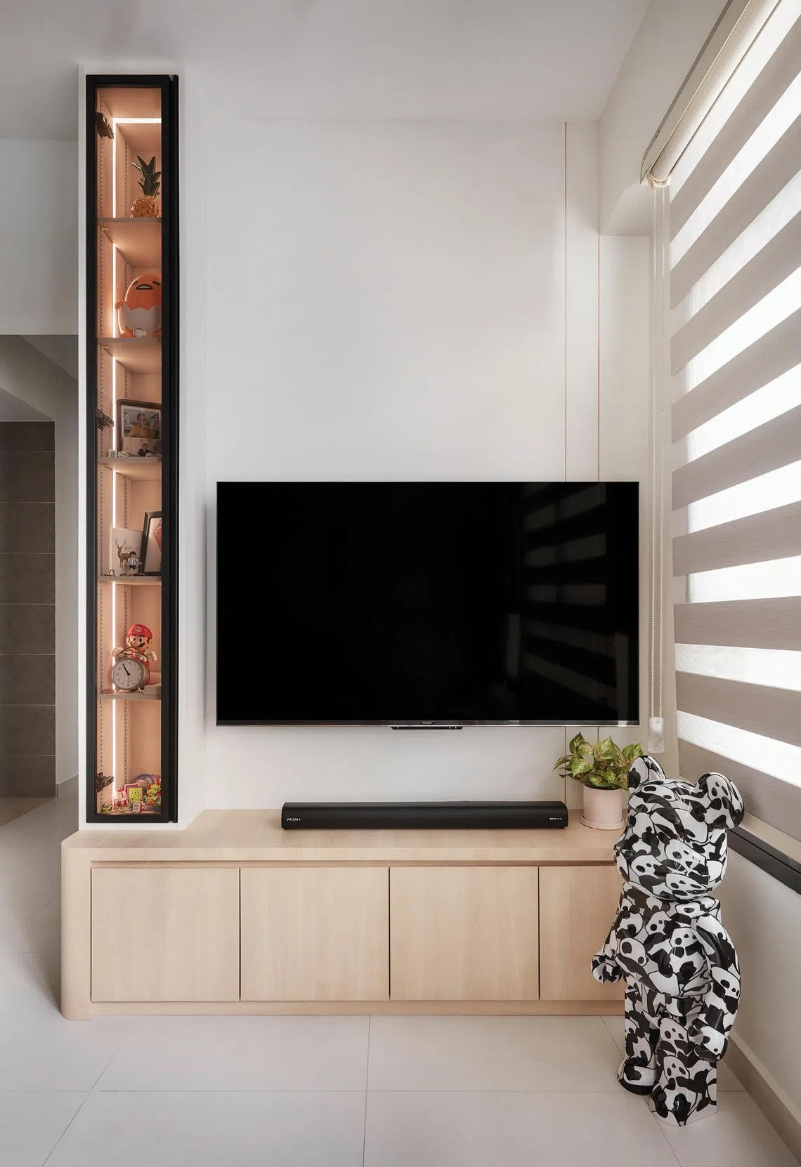 A Bearbrick figure occupies a prominent position in the living area.