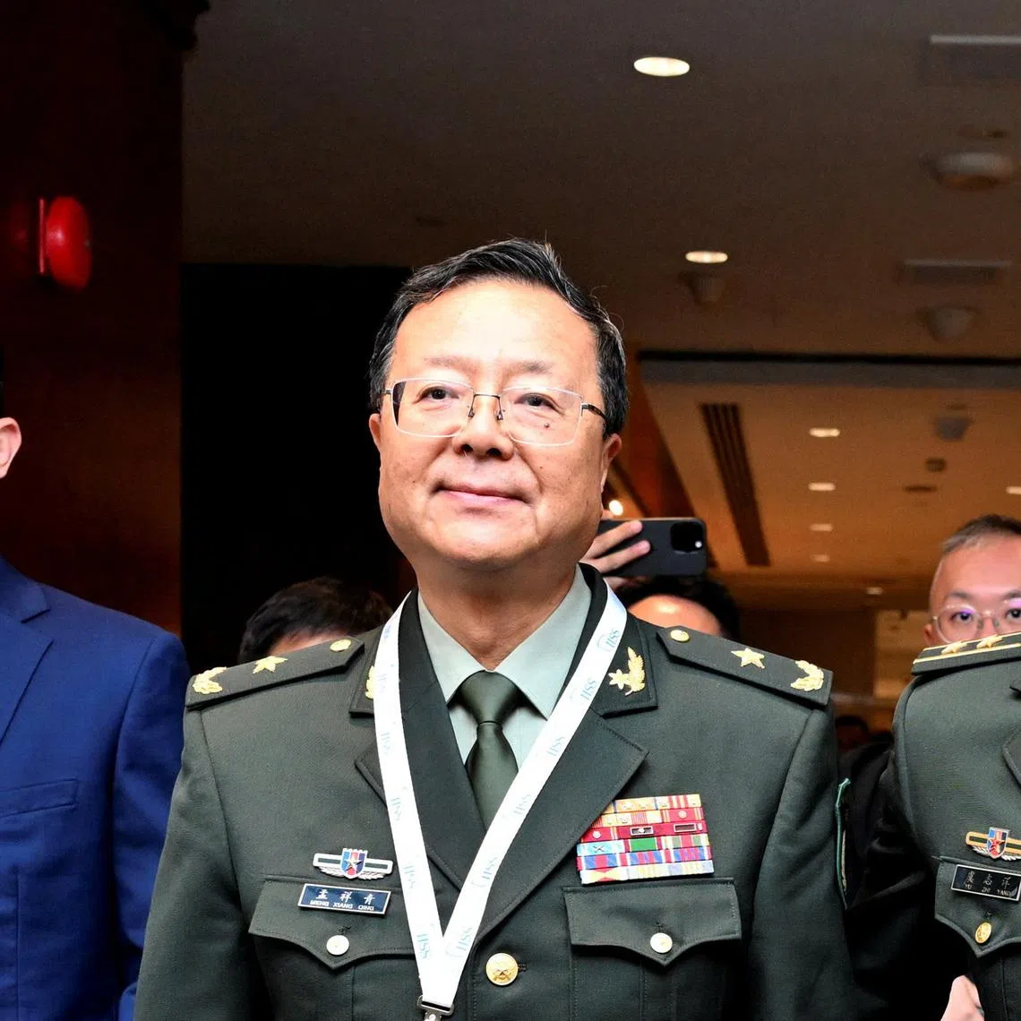 Major General Meng Xiangqing (front, left), the head of the Chinese official delegation, arriving at the Shangri-La Dialogue on May 30.