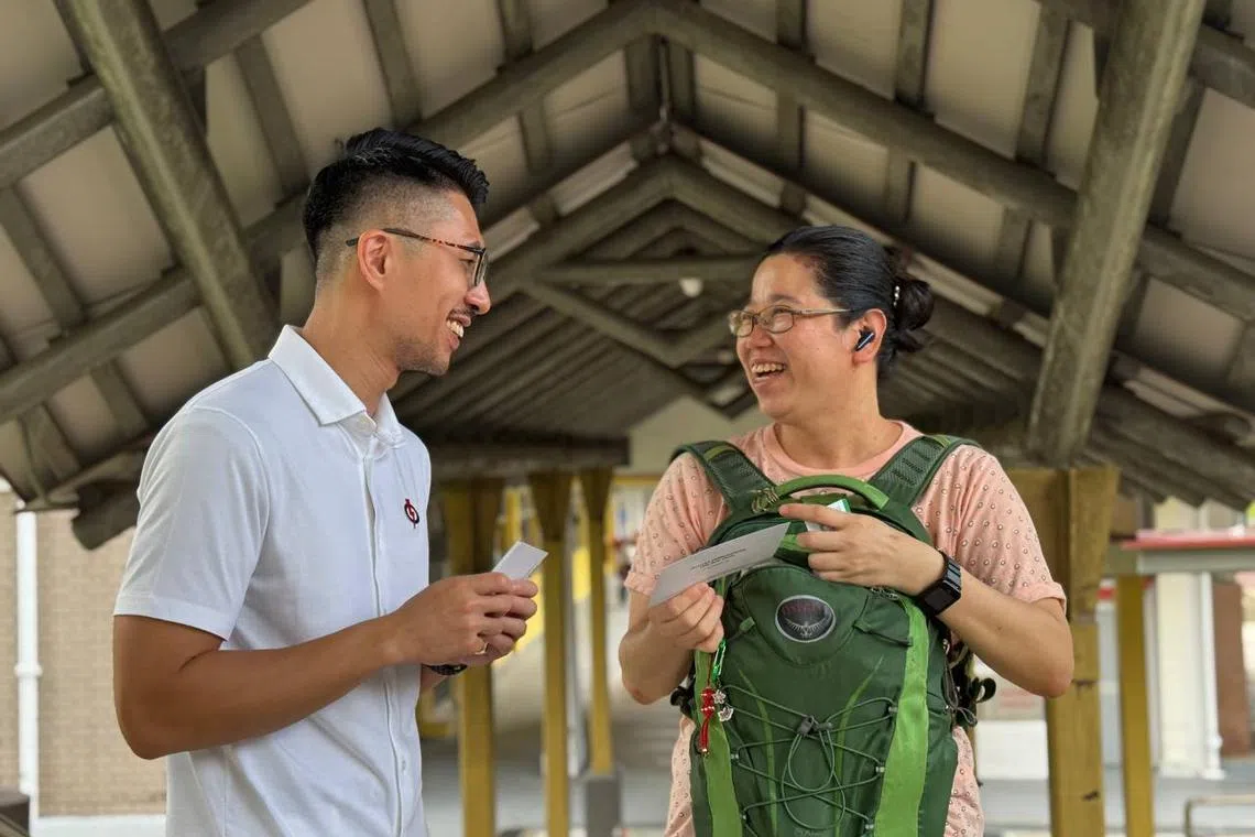 PAP candidate Marshall Lim introducing himself to a Hougang resident on April 24.