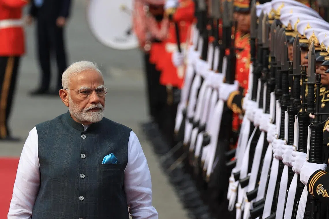 India's Prime Minister Narendra Modi reviews the honor guard at the Government House in Bangkok, Thailand, April 3, 2025. REUTERS/Athit Perawongmetha
