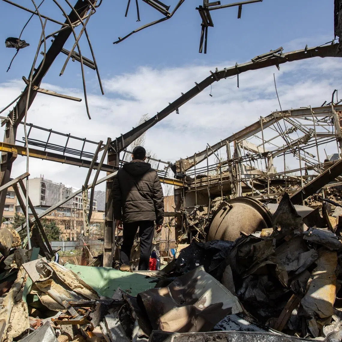 A man navigates the rubble of a building at Shahid Beheshti University in Tehran after it was targeted by US-Israeli airstrikes, on April 4, 2026.