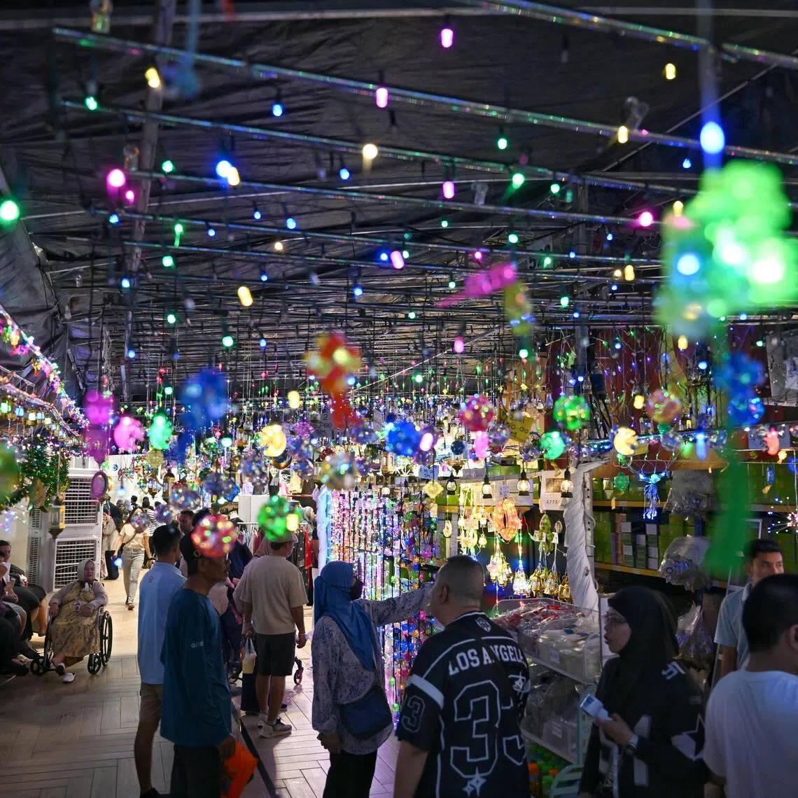The rain-sodden streets of Geylang Serai glistened as the annual Hari Raya light-up kicked off on Feb 14.