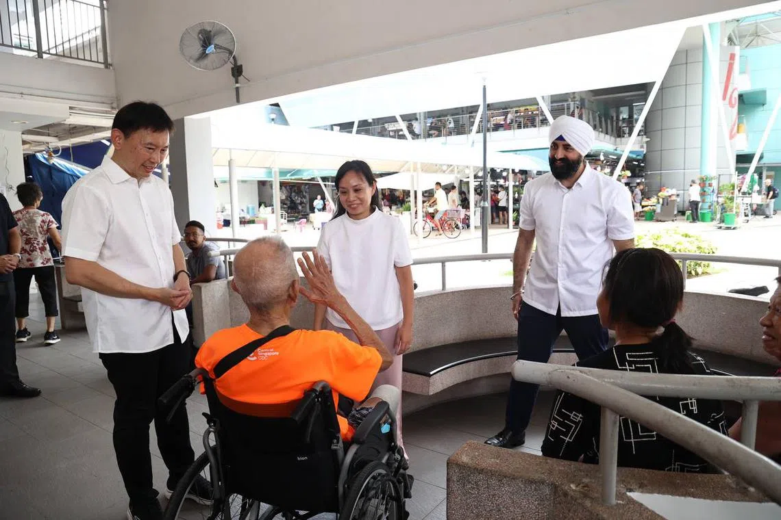 New faces Elysa Chen (centre) and Kawal Pal Singh (right) together with Transport Minister Chee Hong Tat interacting with residents at Toa Payoh West Market & Food Centre, on April 13.