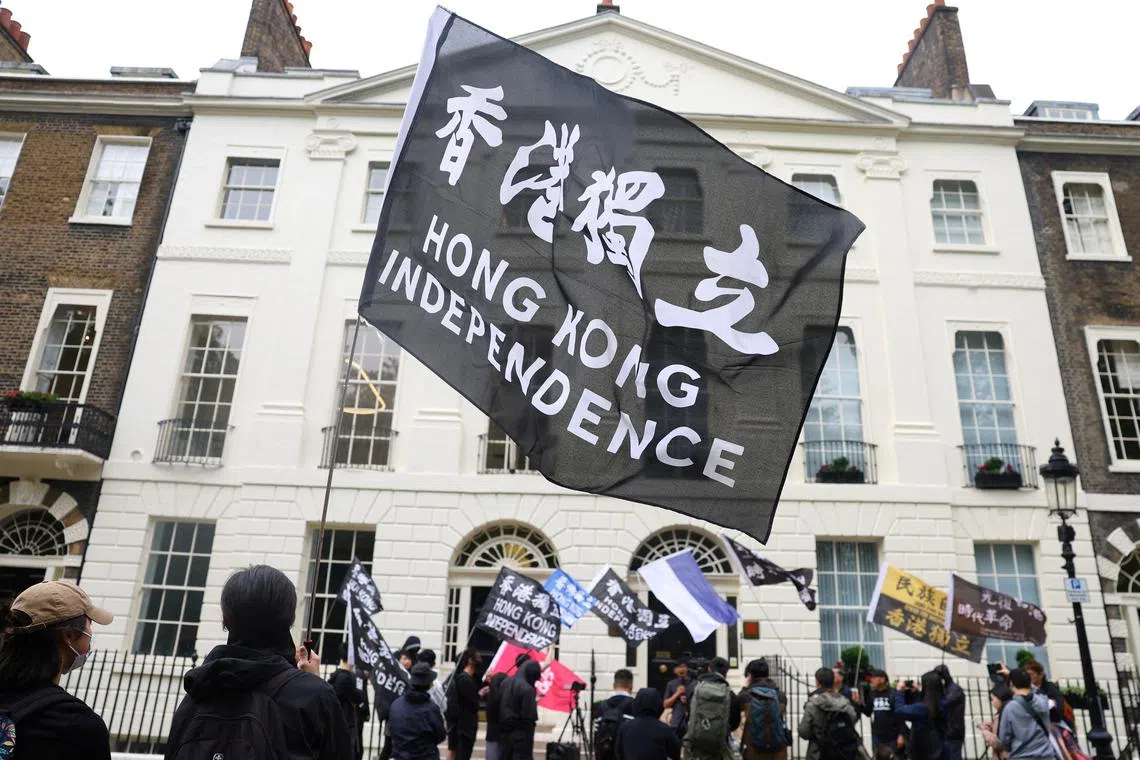 FILE PHOTO: People demonstrate outside the Hong Kong Economic and Trade Office in London, in support of the arrest of three men later charged with assisting Hong Kong's foreign intelligence service in Britain. Picture taken on May 14, 2024. REUTERS/Toby Melville/File Photo
