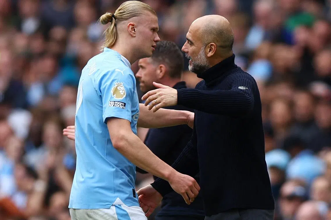 Soccer Football - Premier League - Manchester City v Luton Town - Etihad Stadium, Manchester, Britain - April 13, 2024 Manchester City's Erling Braut Haaland with manager Pep Guardiola after being substituted REUTERS/Molly Darlington