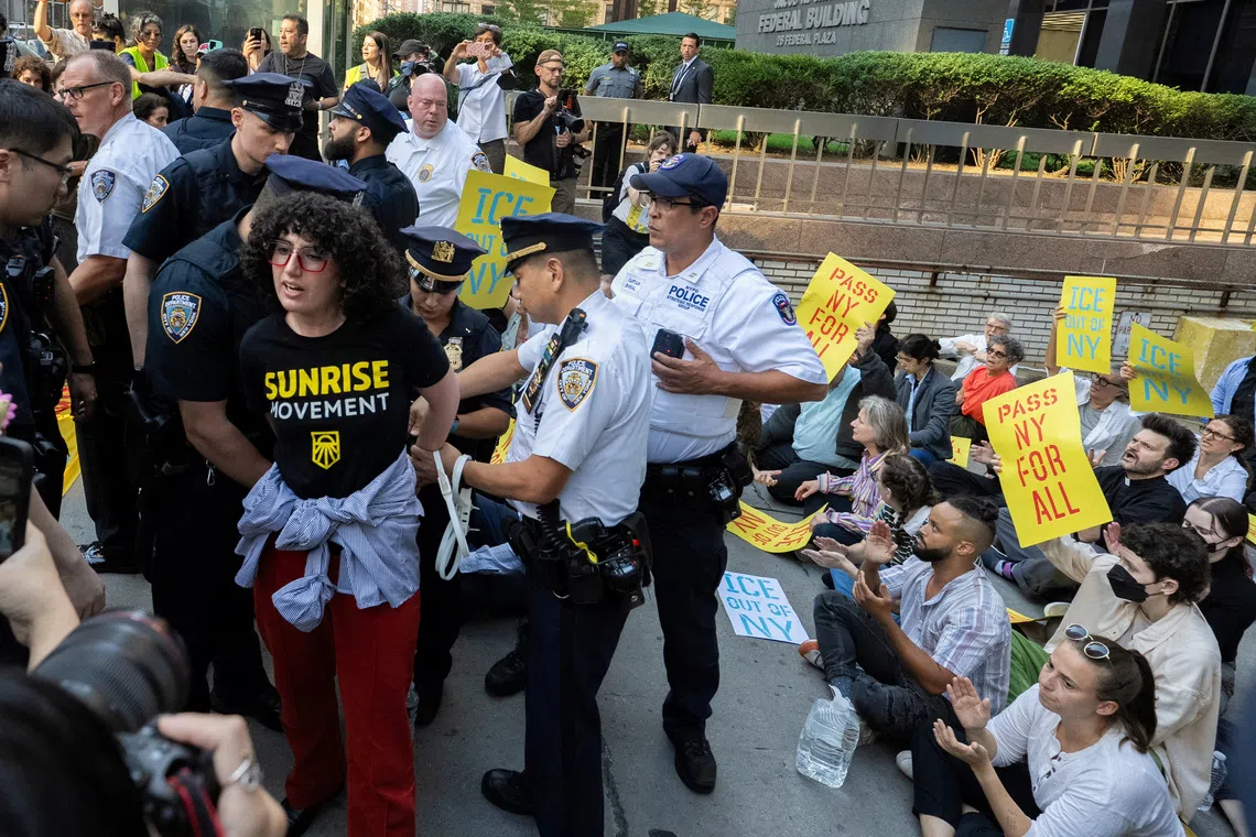 A person is detained by the New York City Police Department during a protest against ICE outside US Immigration Court in Manhattan, New York City, on Sept 18.