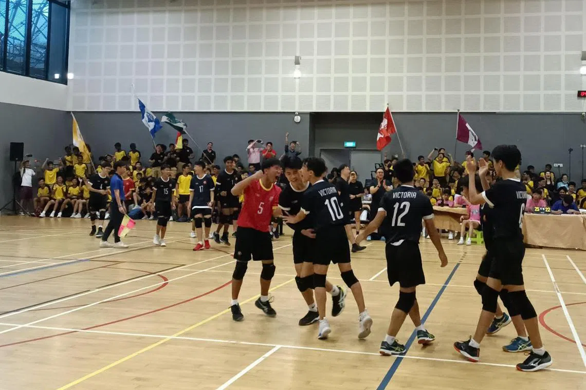 Victoria School players celebrating after winning their first-ever C Division boys' volleyball title on Aug 27.