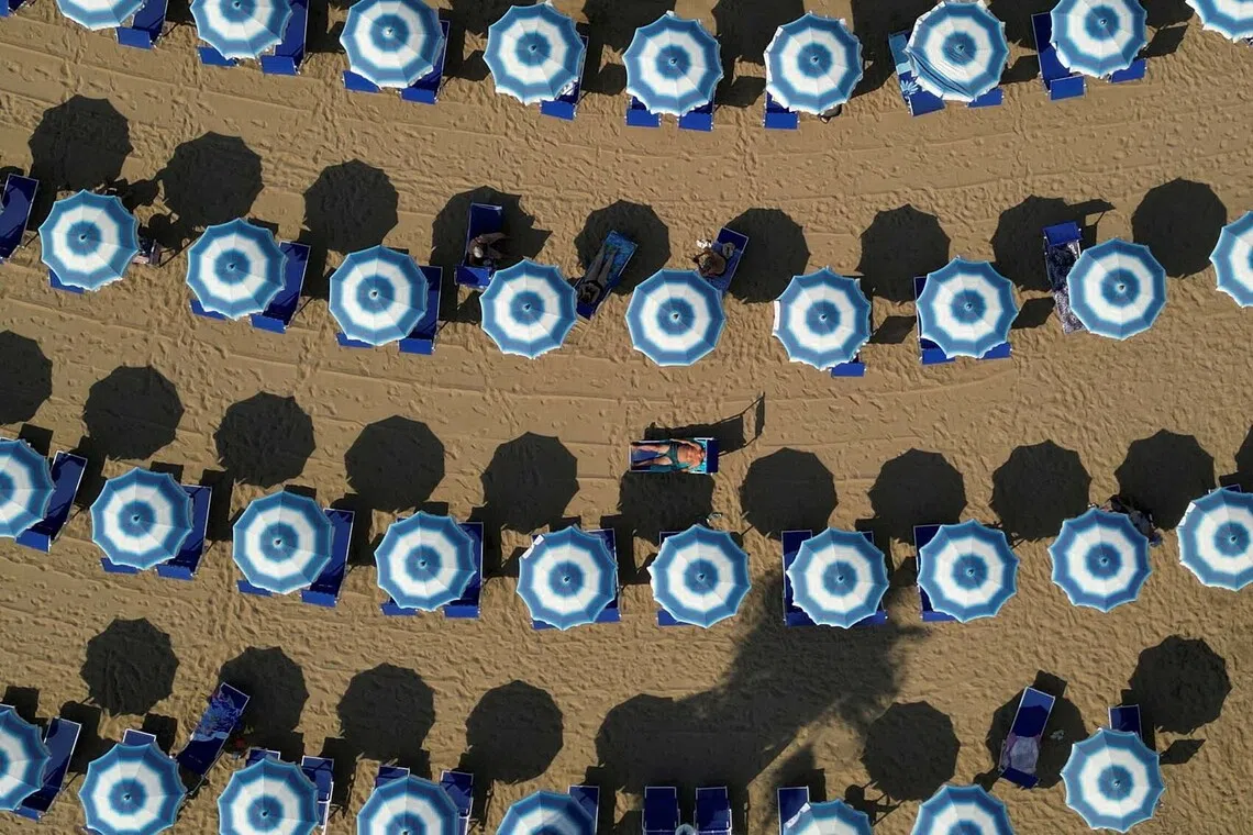 A drone view shows sunbathers with paid umbrellas and sun loungers at a privately run lido operating under a beach concession during a summer marked by repeated heatwaves across Europe, in Santa Severa, Italy, July 29, 2026. REUTERS/Yara Nardi TPX IMAGES OF THE DAY