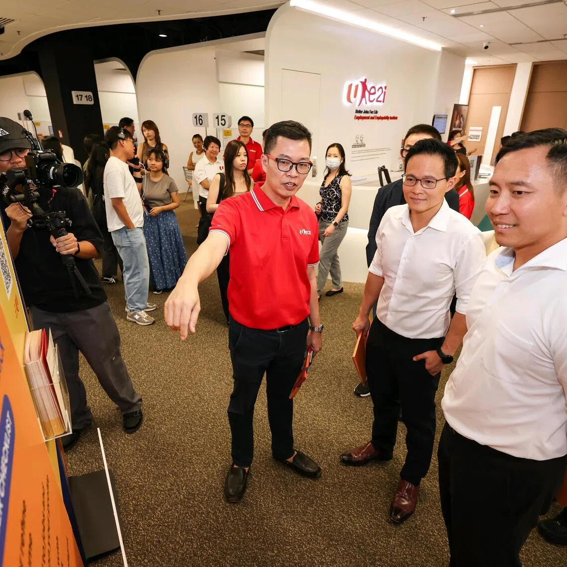 (From left) Mr Justin Ting, 54, e2i career coach, giving Mr Desmond Choo, NTUC deputy secretary-general, and Mr Goh Pei Ming, Minister of State for Education and Social and Family Development, a tour of the career centre during the Economic Strategy Review Committee media visit at the Devan Nair Institute for Employment and Employability on Feb 9, 2026. ST PHOTO: BRIAN TEO