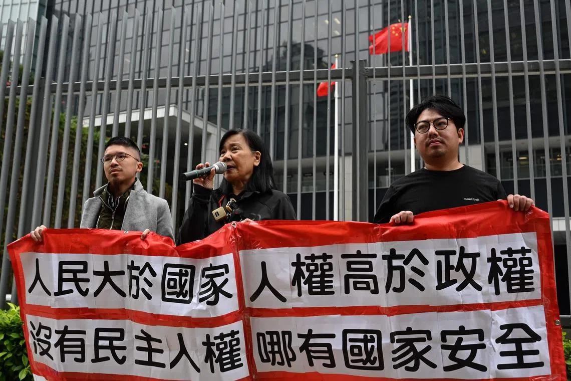 Members of the League of Social Democrats hold up a banner which reads "Without democracy, there can be no livelihood" outside the Central Government offices in Hong Kong on Feb 27.