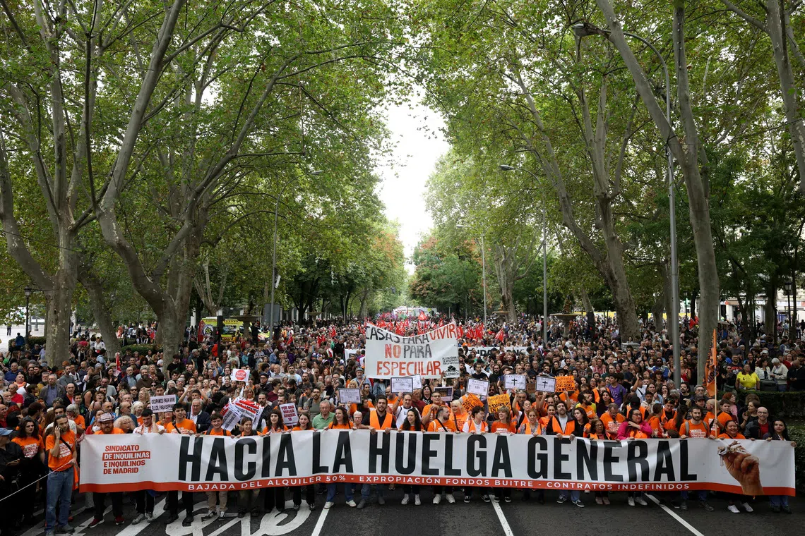 Protesters carry a banner that reads “Towards the general strike” as they demand political action to stop evictions and alleviate the housing crisis, in Madrid, Spain, on Oct 3.