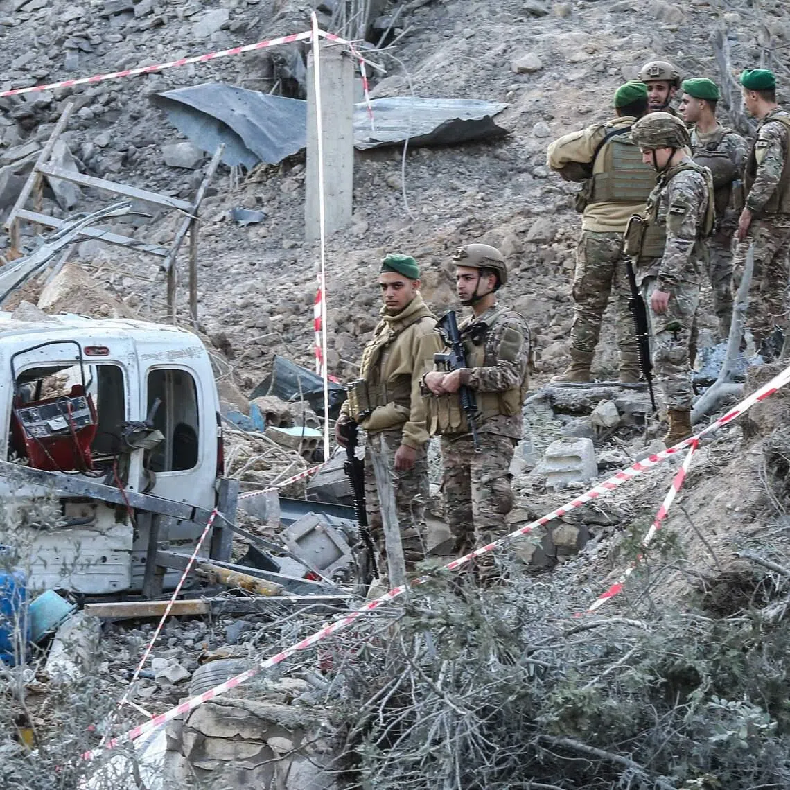 Lebanese soldiers inspecting a site after an Israeli air strike in the southern Lebanese village of Kfar Dounine on Jan 25.