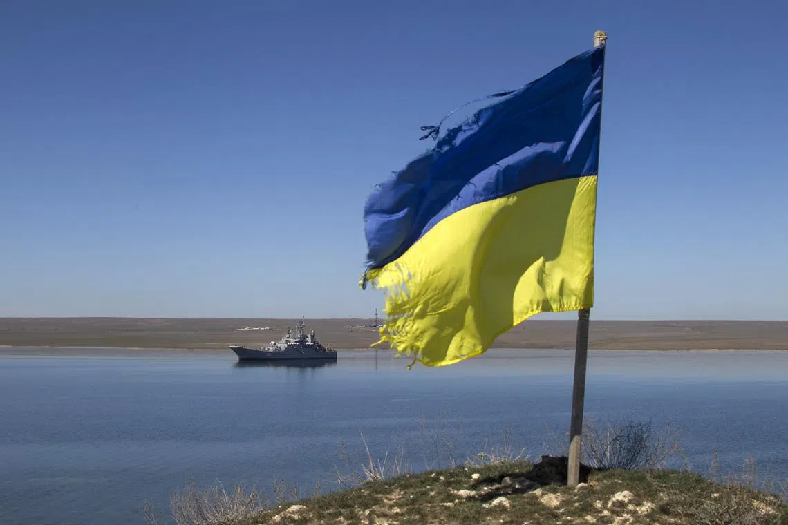 FILE PHOTO: A Ukrainian flag placed by a family member of a sailor on board the Ukrainian naval landing vessel \"Konstantin Olshansky\" is seen in the blockaded Donuzlav bay in Crimea March 23, 2014. REUTERS/Baz Ratner/File Photo