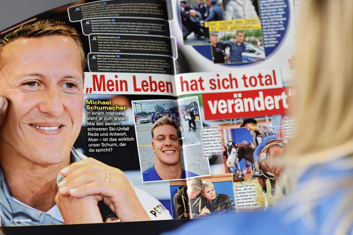 A woman reading the issue of German weekly magazine Die Aktuelle with the cover announcing a fake interview with Michael Schumacher, in Berlin, on April 20,  2023. 